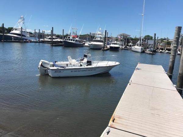 21′ Outrage Boston Whaler Image 5 The 21' Outrage tied to a doc in front of other boats