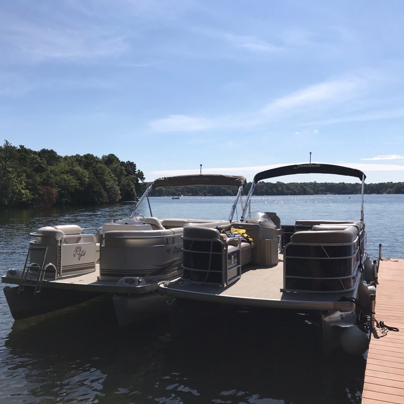 Two pontoon boats ties to the doc
