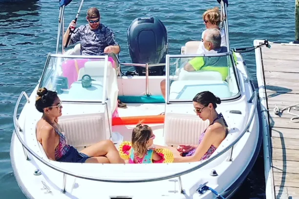 A family on a boat at the doc