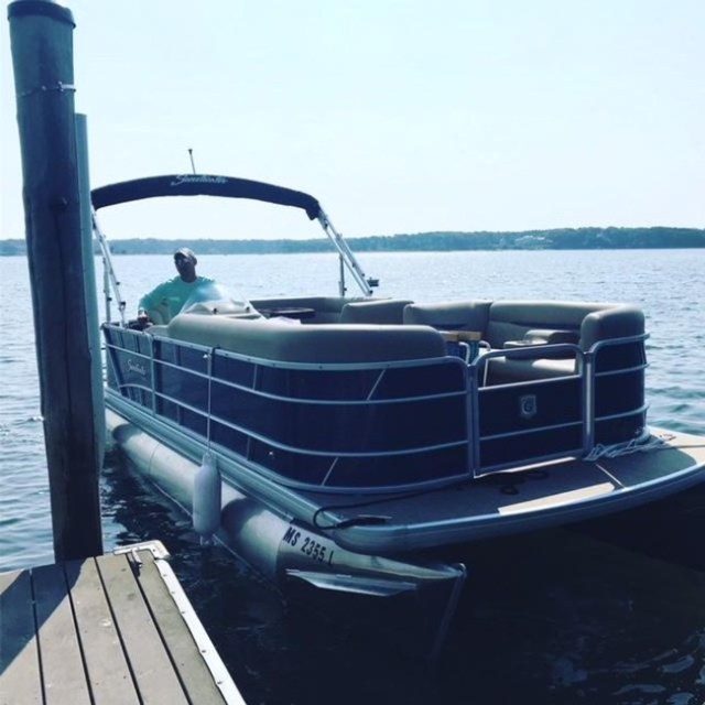 A pontoon boat at a doc